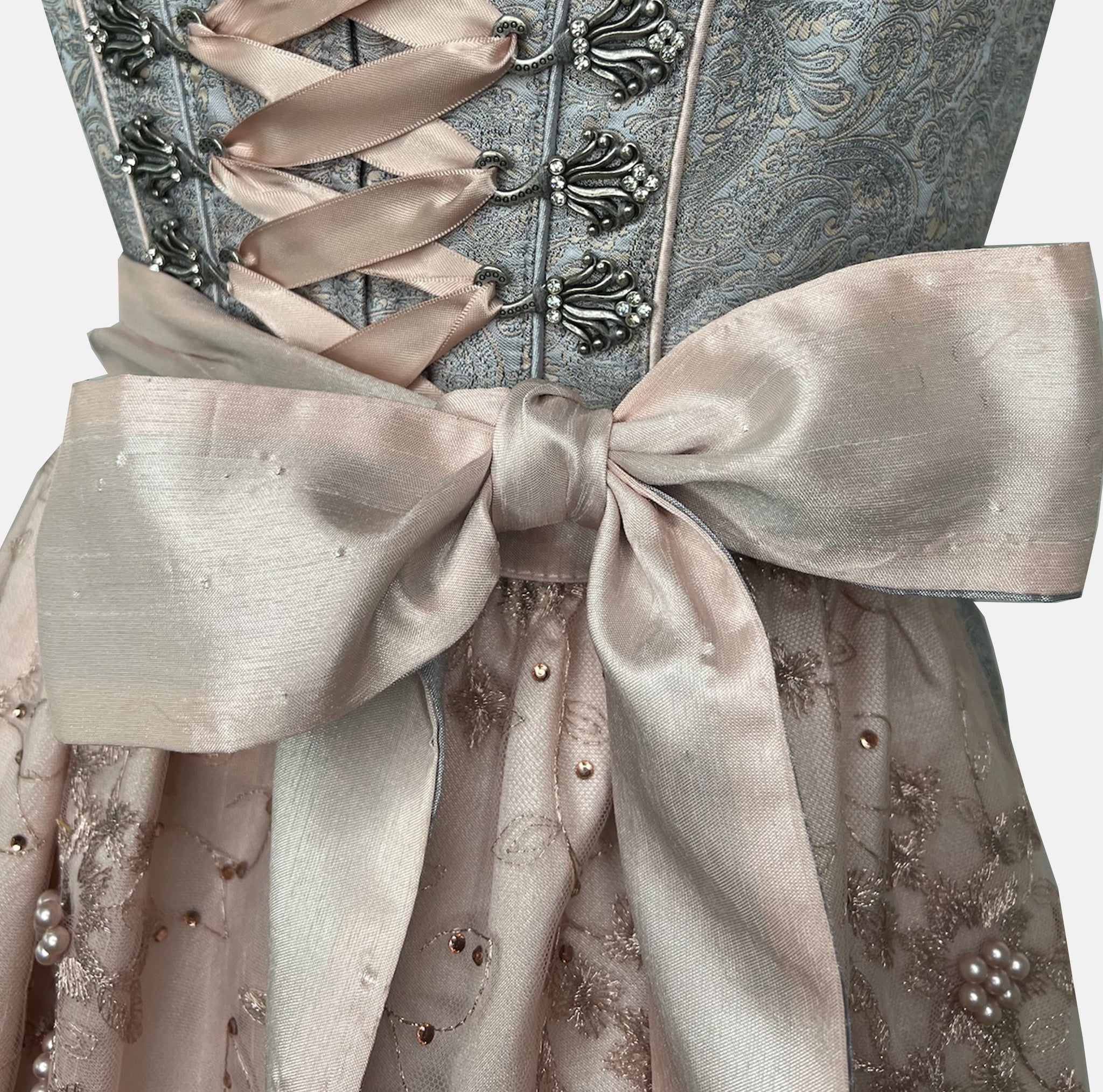 Krüger Dirndl with dusty blue bodice and pink embroidered apron. Available to rent on Versatile. Romantic, detailed, and perfect for Oktoberfest.