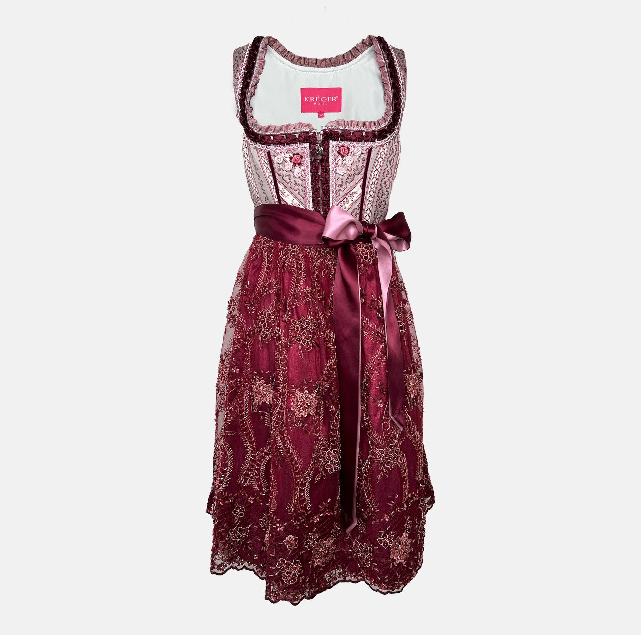 Burgundy Krüger dirndl with floral lace embroidery, satin ribbon bow, and decorative bodice – available for rent at Versatile OTM.