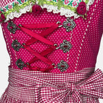 Krüger pink dirndl rental via Versatile – polka-dot bodice with ribbon lacing, gingham apron and floral trim, playful Oktoberfest outfit