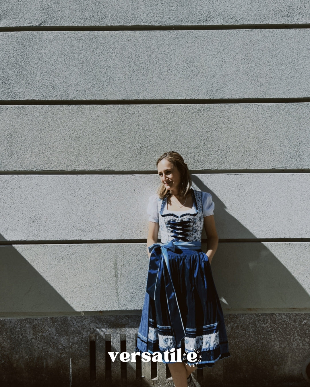 Blue floral Krüger mini dirndl with heart neckline and fitted bodice – stylish Oktoberfest rental in Munich via Versatile OTM
