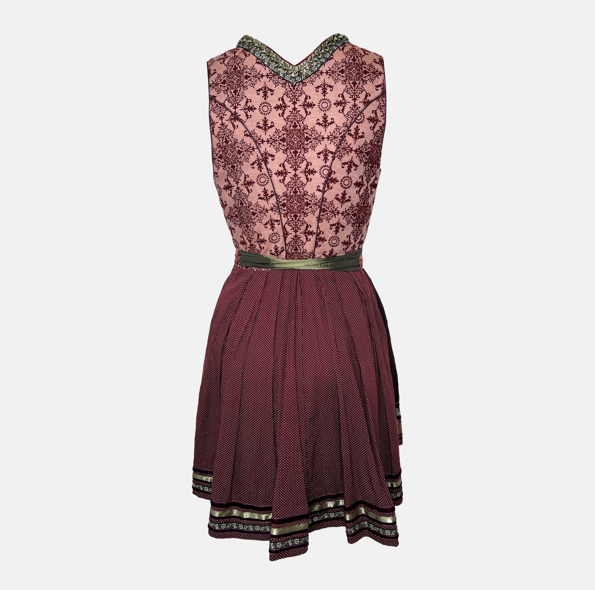 Krüger Dirndl in deep berry and burgundy tones with satin apron and intricate detailing, available for rent on Versatile OTM.