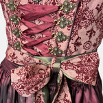 Krüger Dirndl in deep berry and burgundy tones with satin apron and intricate detailing, available for rent on Versatile OTM.