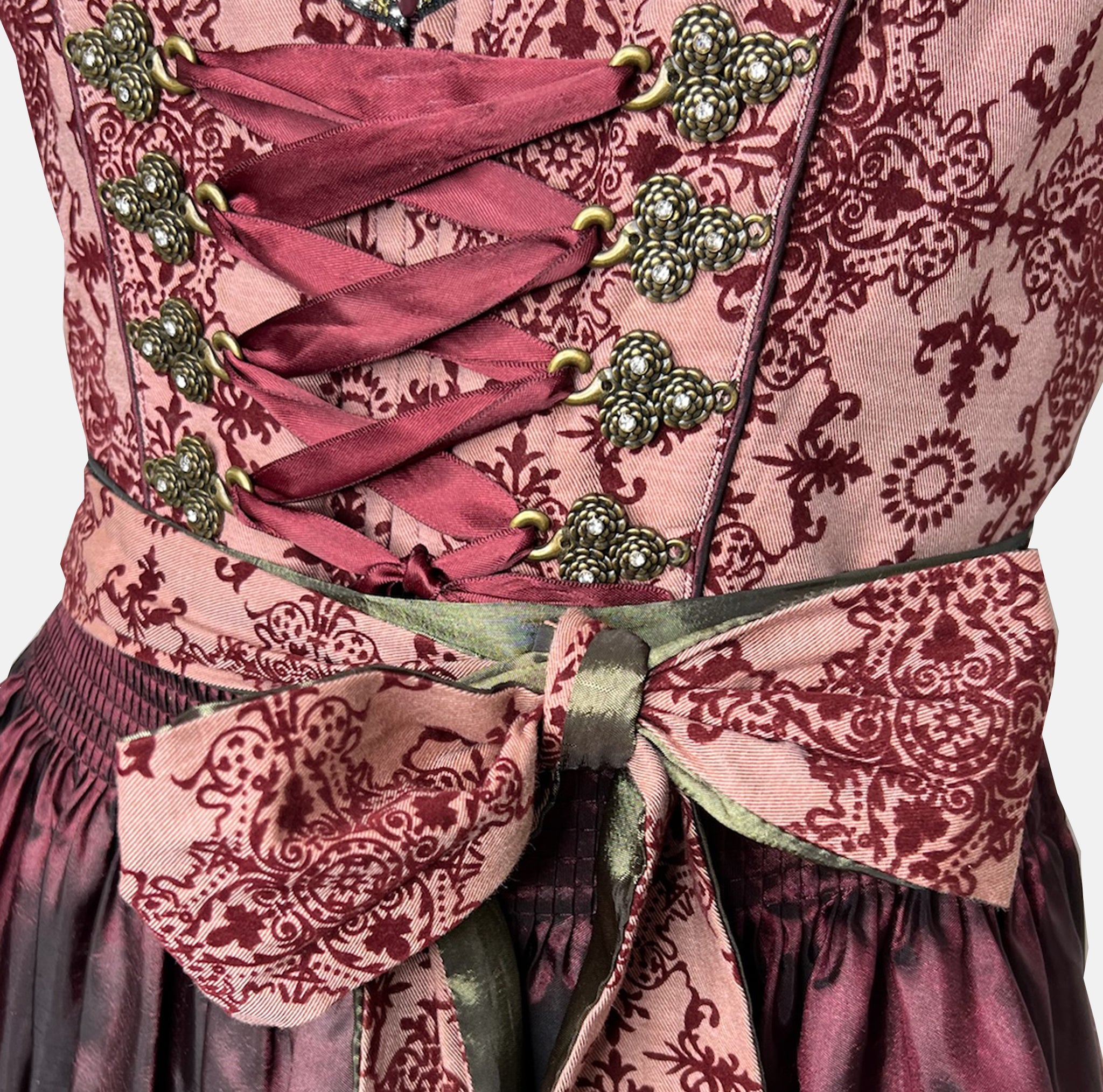Krüger Dirndl in deep berry and burgundy tones with satin apron and intricate detailing, available for rent on Versatile OTM.