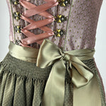 Traditional German dirndl dress by Krüger with a green apron for rent - online or in Munich