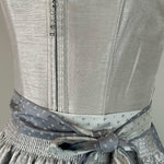 Elegant silver Krüger dirndl with lace details and patterned apron. Rent in Munich or online – perfect for Oktoberfest, weddings, and festive occasions.