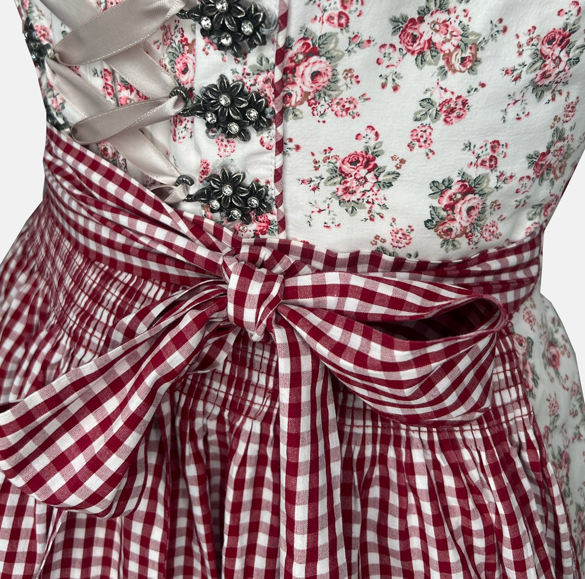Rent floral Krüger Dirndl with red gingham apron, lace trim, and feminine details – ideal for Oktoberfest or stylish Bavarian celebrations.