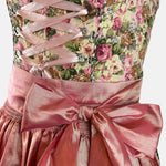 Rose-gold dirndl with floral bodice and satin apron, available for Oktoberfest rental in Munich