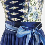 Bold blue dirndl dress with floral top and navy skirt on a white background for rent