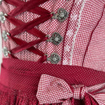 Red Krüger dirndl with checkered bodice and gingham apron for Oktoberfest rental