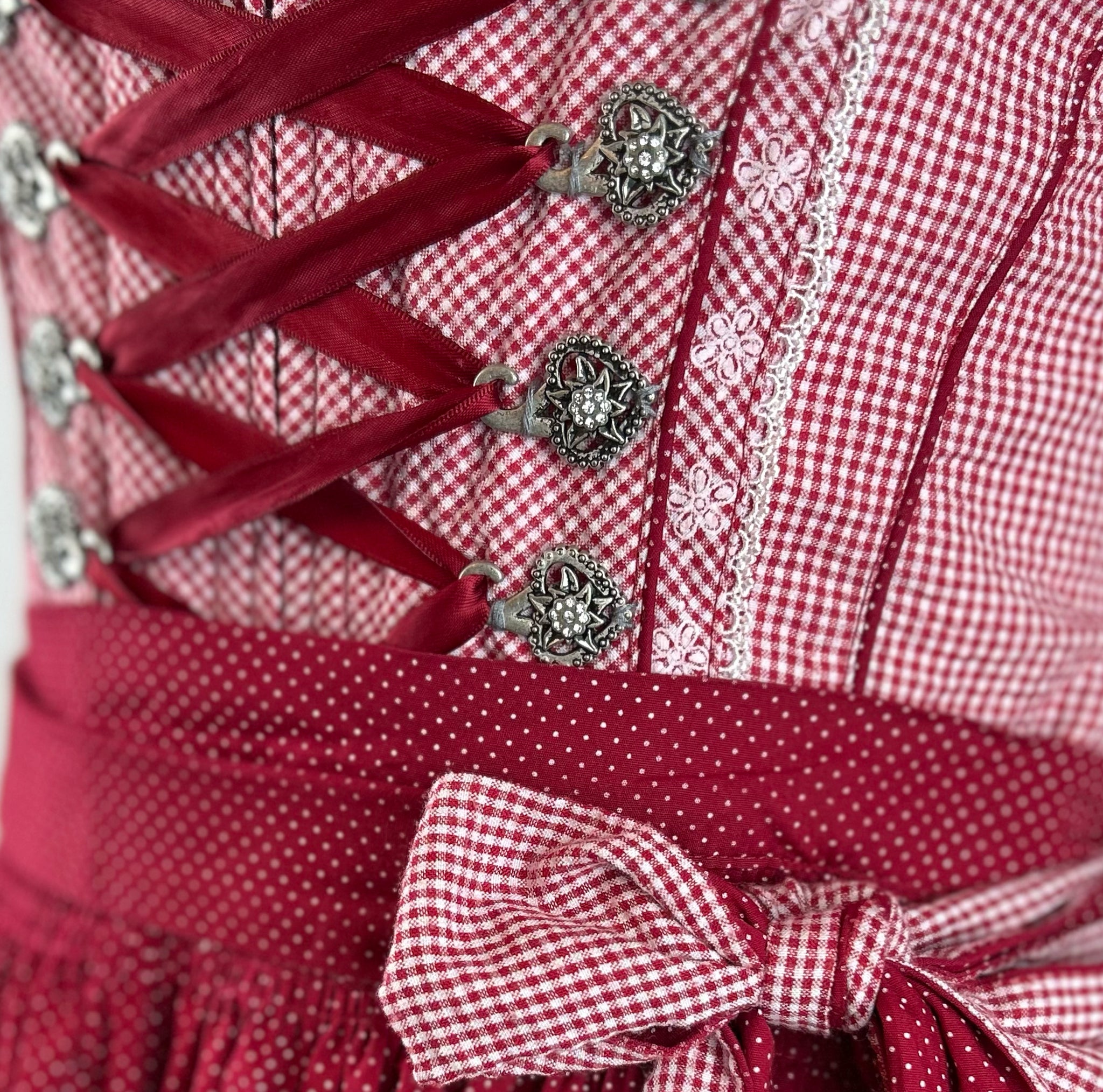 Red Krüger dirndl with checkered bodice and gingham apron for Oktoberfest rental
