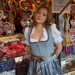 A woman wearing a traditional German Krüger Dirndl ready to rent on Versatile OTM. Krüger Dirndl Bea with Dirndl Blouse