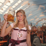 A women wearing a rented Krüger Dirndl from Versatile OTM. Traditional German Oktoberfest Dirndl in a beer tent.