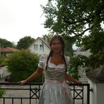 Girl wearing the Krueger Dirndl Ida rented for Oktoberfest. Traditional German Dirndl ready to rent on Versatile OTM 