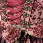 Krüger Dirndl in deep berry and burgundy tones with satin apron and intricate detailing, available for rent on Versatile OTM.