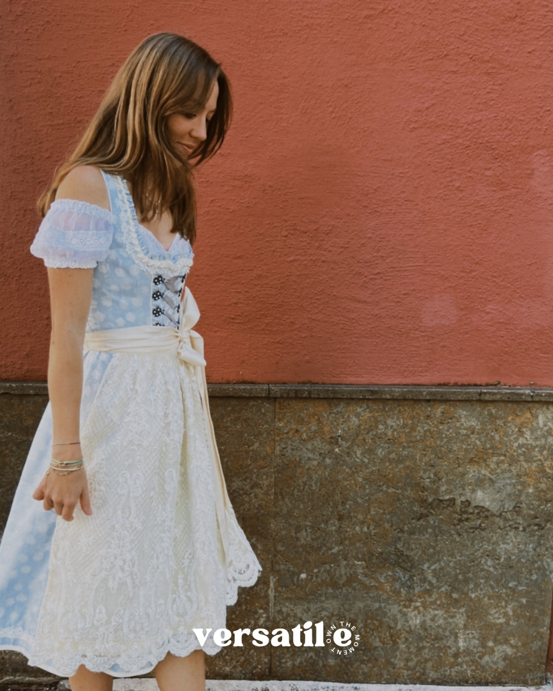 Rent Krüger Dirndl Maylin in Munich: elegant blue midi dress with lace apron, front zipper, side pockets, and flattering fit—Oktoberfest ready.