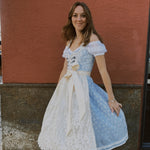 Munich Oktoberfest rental: Krüger Maylin dirndl with pastel blue heart neckline, lace apron, 70 cm midi skirt, and practical pockets.