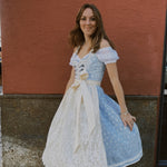 Munich Oktoberfest rental: Krüger Maylin dirndl with pastel blue heart neckline, lace apron, 70 cm midi skirt, and practical pockets.