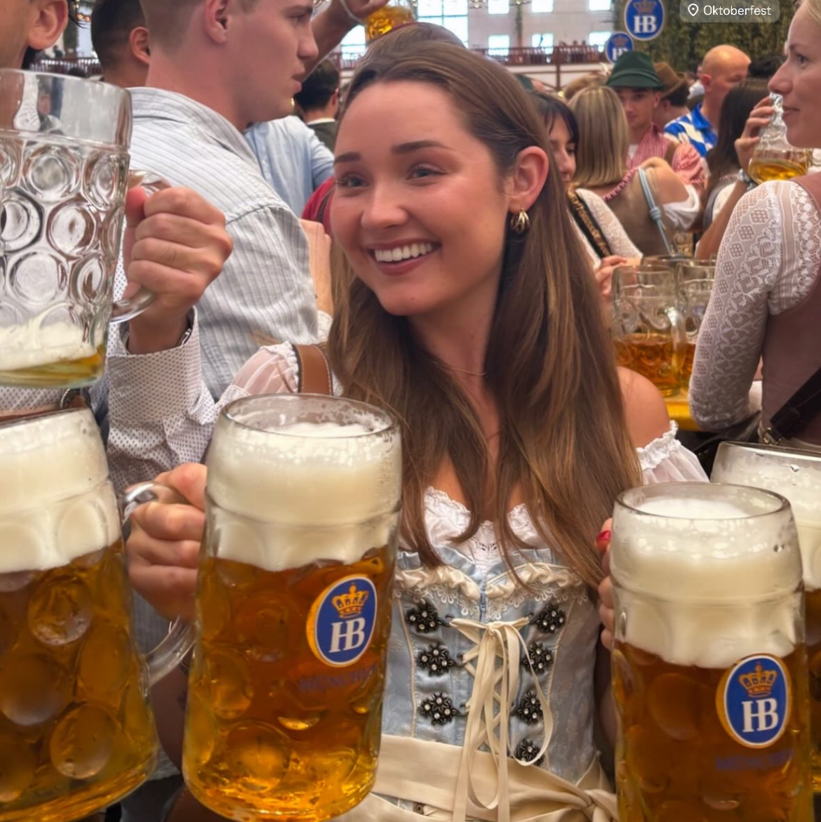 A women wearing a rented Krüger Dirndl from Versatile OTM. Traditional German Oktoberfest Dirndl in a beer tent.