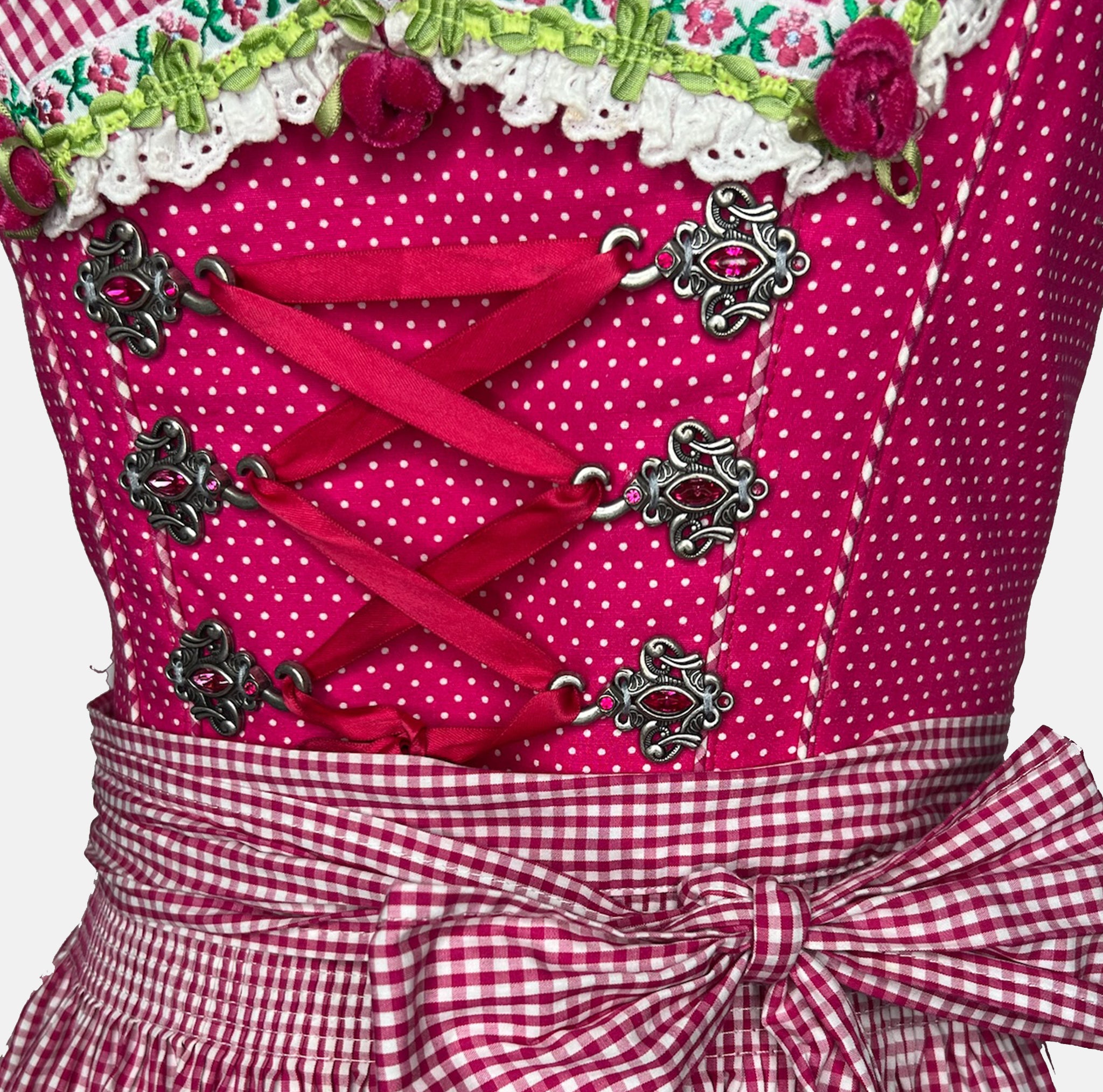 Krüger pink dirndl rental via Versatile, polka-dot bodice with ribbon lacing, gingham apron and floral trim, playful Oktoberfest outfit