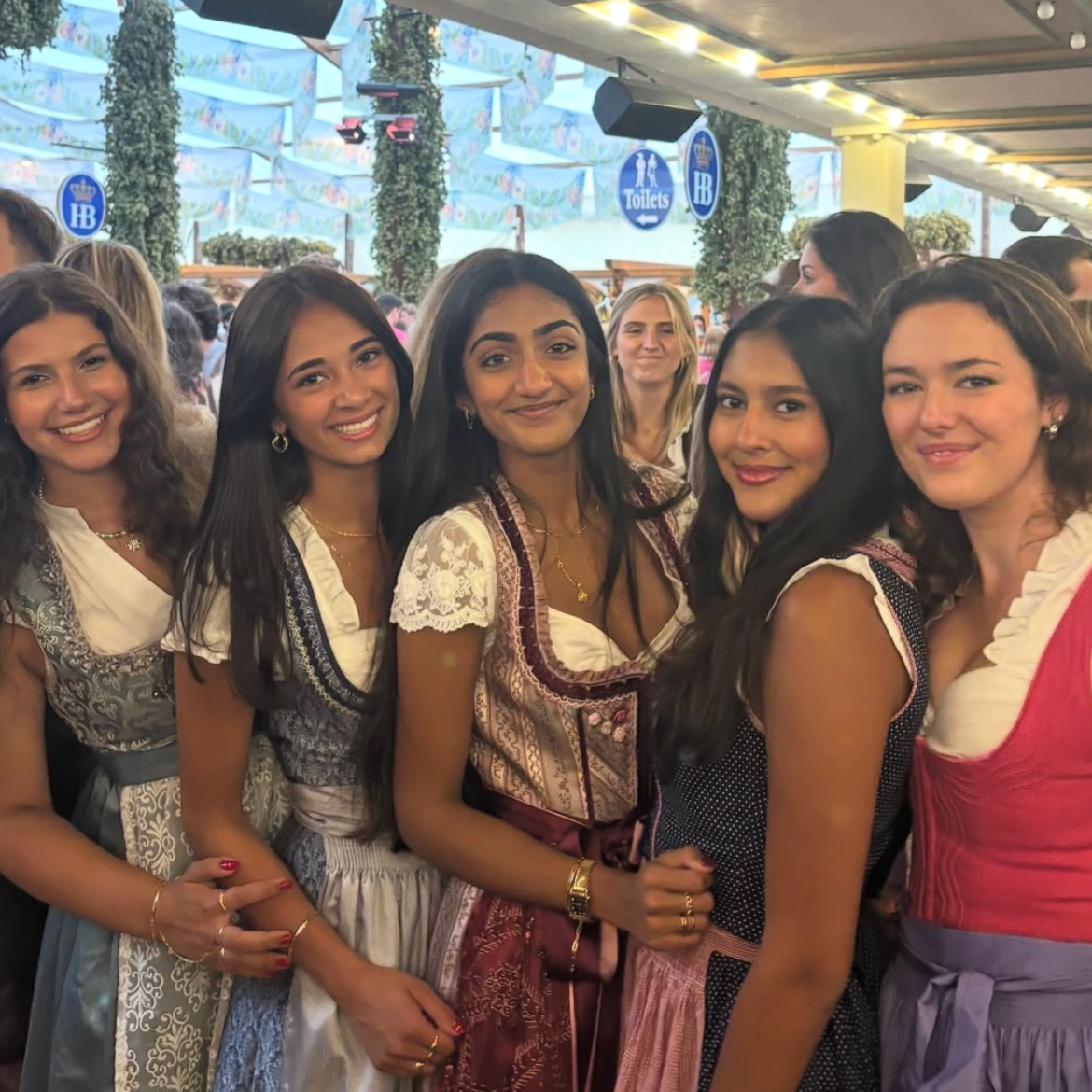 Rented Krueger Dirndl UGC rented on Versatile OTM for Oktoberfest. Four girls wearing Dirndl rented by versatile 