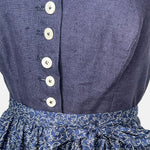 Traditional blue Ludwig & Therese Dirndl with buttoned bodice and patterned apron, available for rent at Versatile OTM.