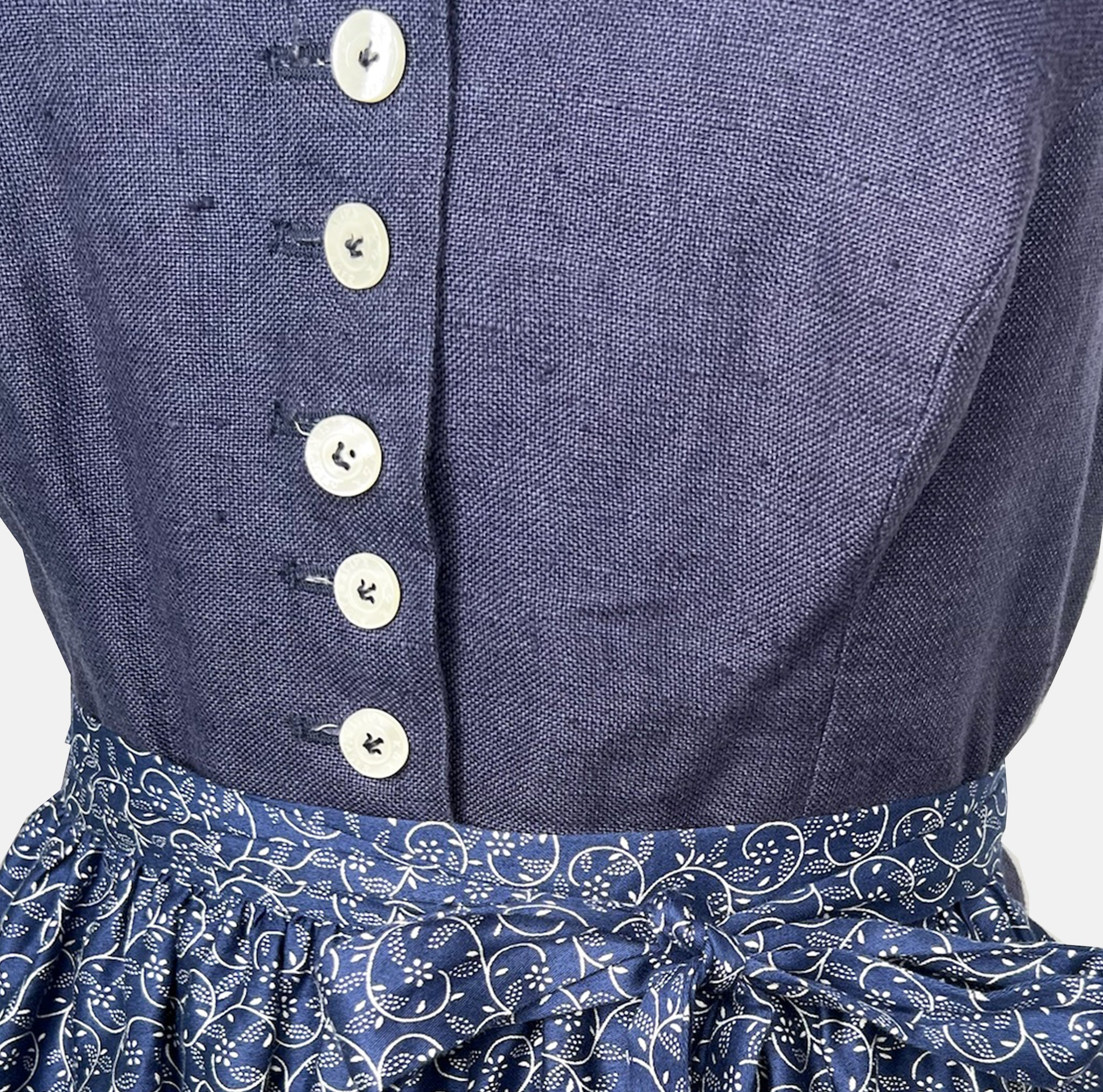 Traditional blue Ludwig & Therese Dirndl with buttoned bodice and patterned apron, available for rent at Versatile OTM.