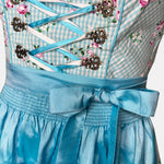 Marjo Bavarian rental dirndl in turquoise with floral embroidered bodice, lace-up detail, and satin apron, available at Versatile OTM in Munich.