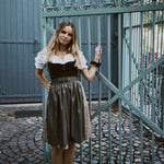 MarJo rental dirndl in Munich—olive velvet V-neck bodice with gold-tone zipper and decorative buckle, A-line 55 cm skirt for Oktoberfest.