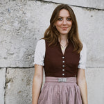 Oktoberfest-ready Marjo dirndl for rent: burgundy jacquard V-neck bodice, silver-tone buttons, beige embossed skirt — available at Versatile OTM Munich.