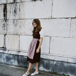Munich dirndl rental — Marjo deep burgundy V-neck with silver buttons and beige textured skirt; perfect for Oktoberfest celebrations.