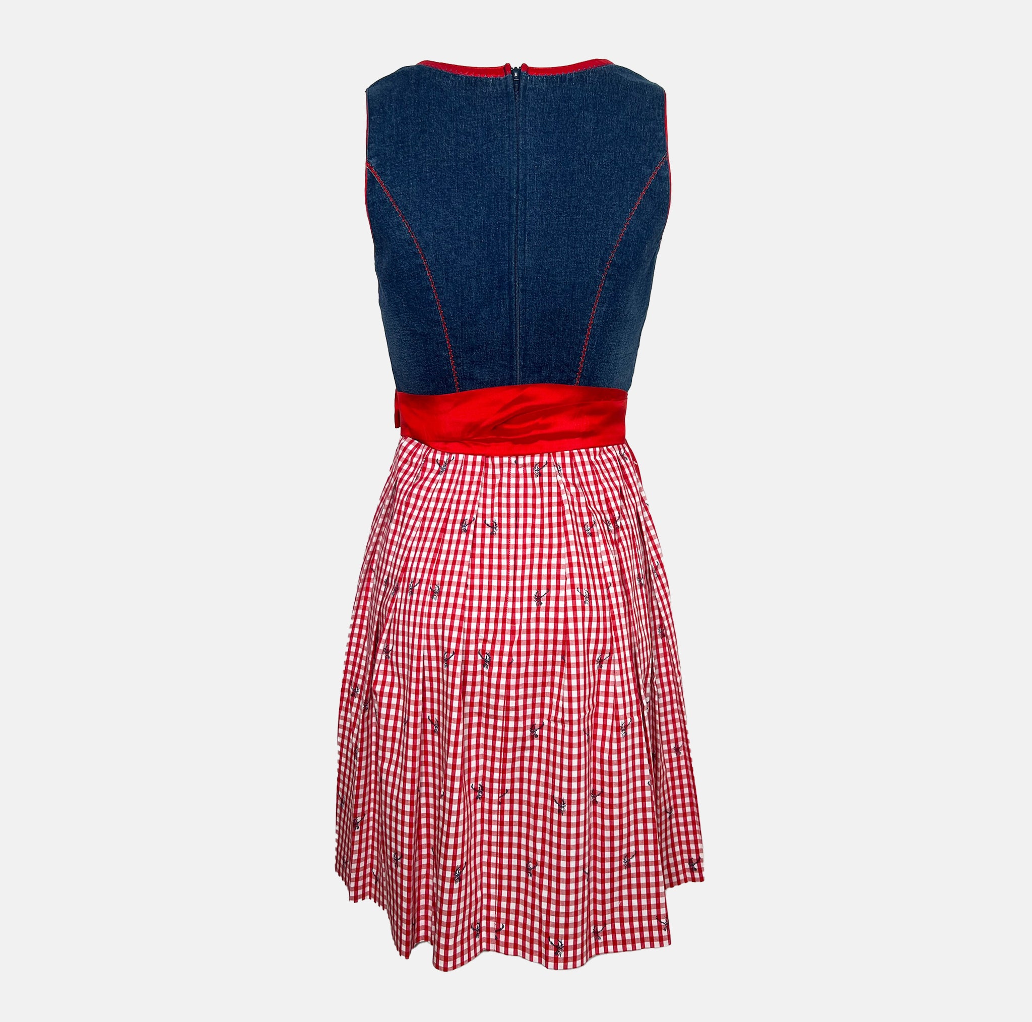 Cheeky red and navy dirndl with gingham bodice, lace-up detail, and red satin apron, available for rental at Versatile OTM, owned by Beer&Pretzel Tours