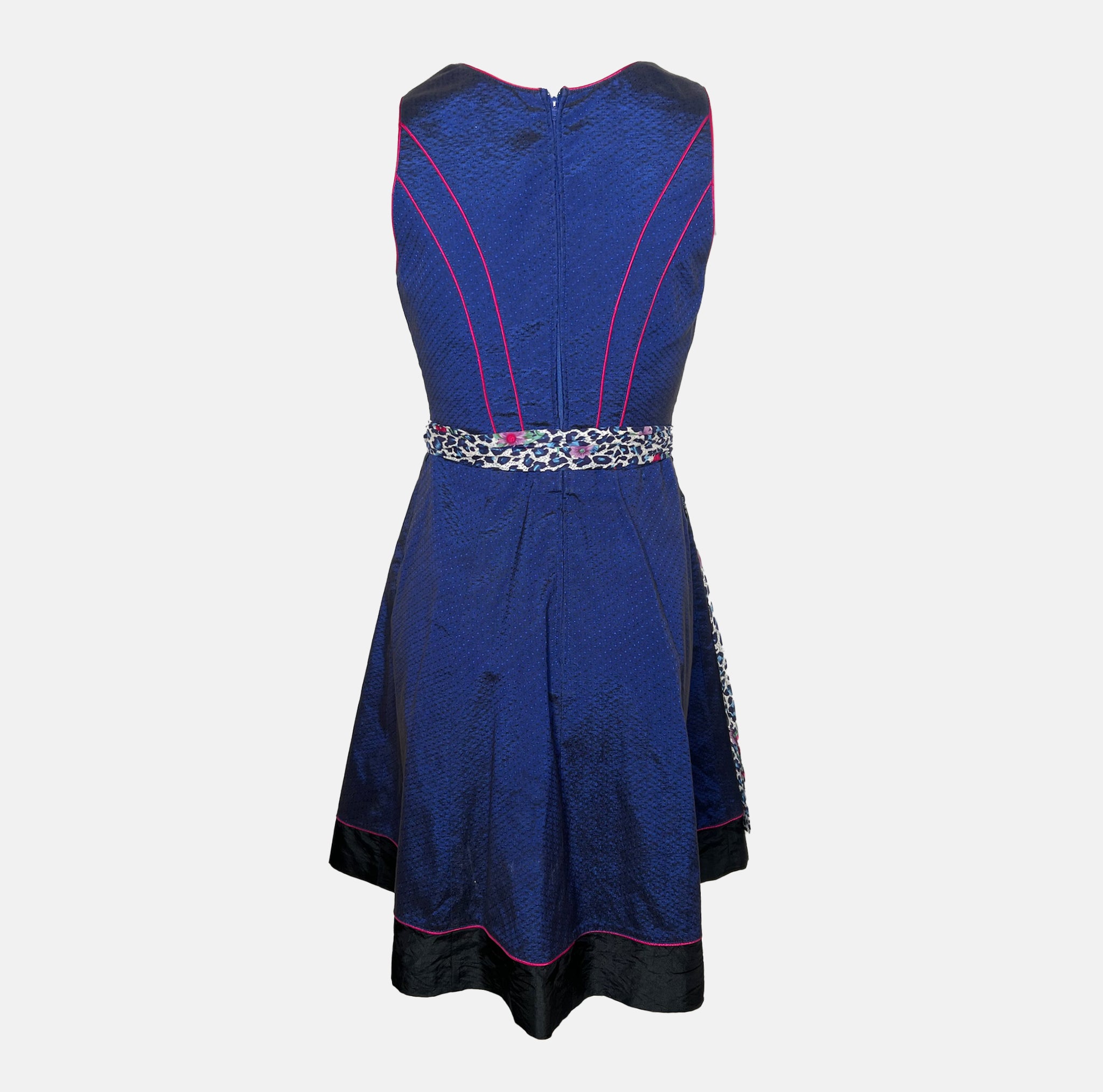 Cheeky dirndl with navy bodice, pink gingham trim, and leopard-print apron with floral accents, available for rental at Versatile OTM, owned by Beer&Pretzel Tours.