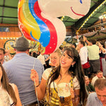 Yellow and brown cheeky dirndl with embroidered bodice and golden apron, available for rental at Versatile OTM, owned by Beer&Pretzel Tours.