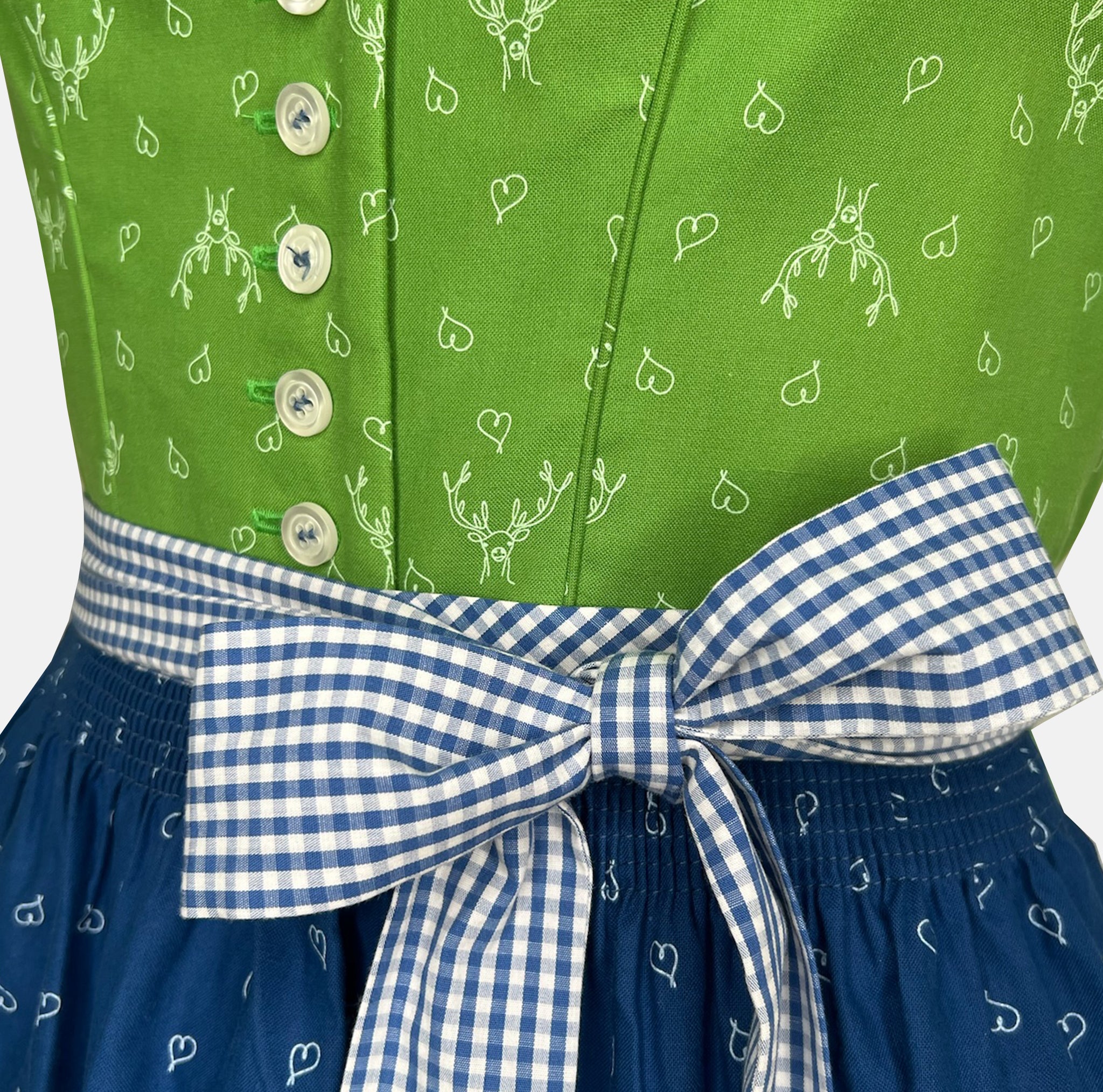 Handmade Trachten Redl dirndl from Munich with green bodice, blue patterned skirt, and matching gingham apron – available for rent at Versatile OTM.