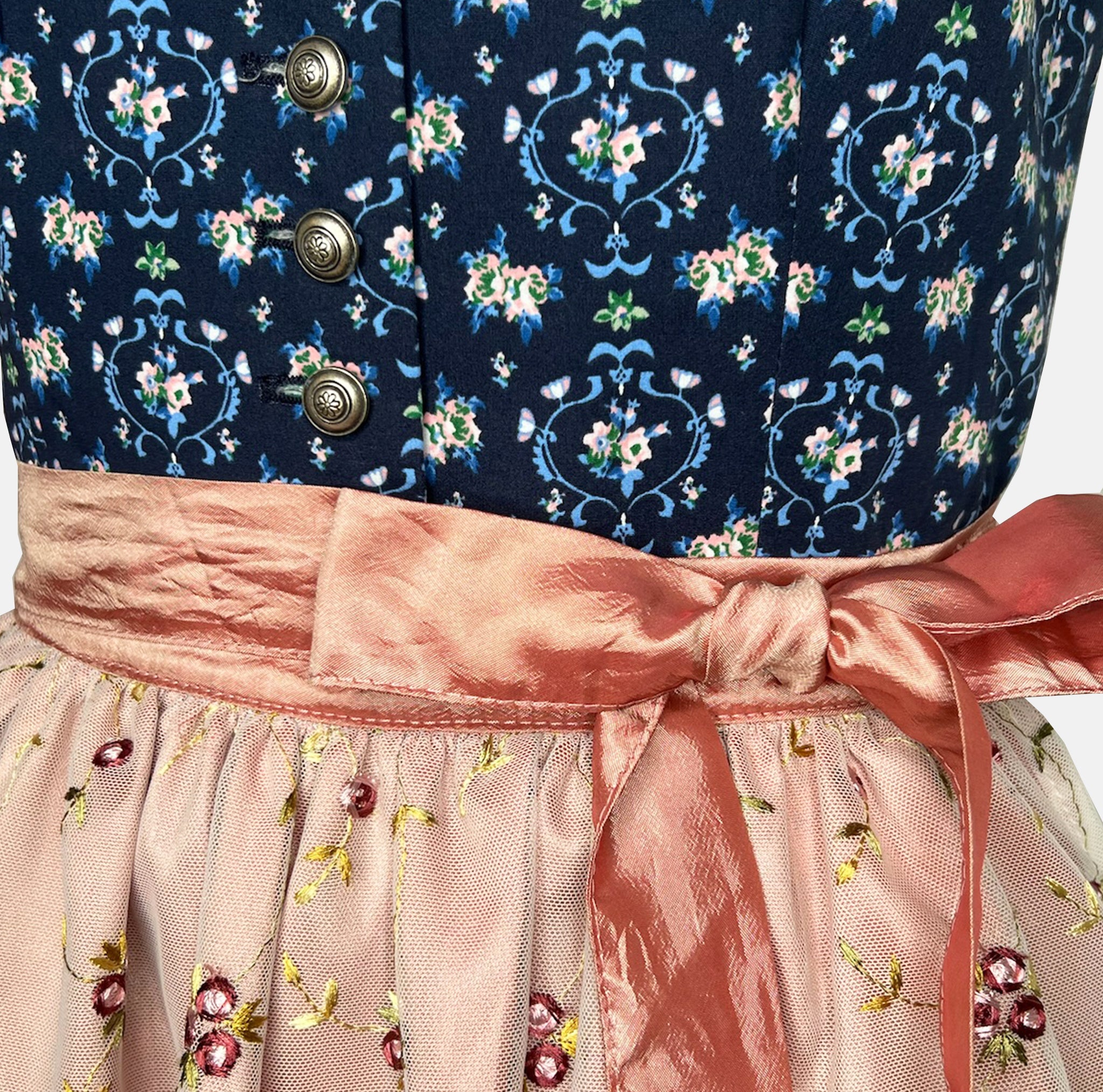 Trachtenmanufaktur Bavarian rental dirndl with navy floral bodice and rose embroidered apron, available at Versatile OTM in Munich, owned by Beer&Pretzel Tours.