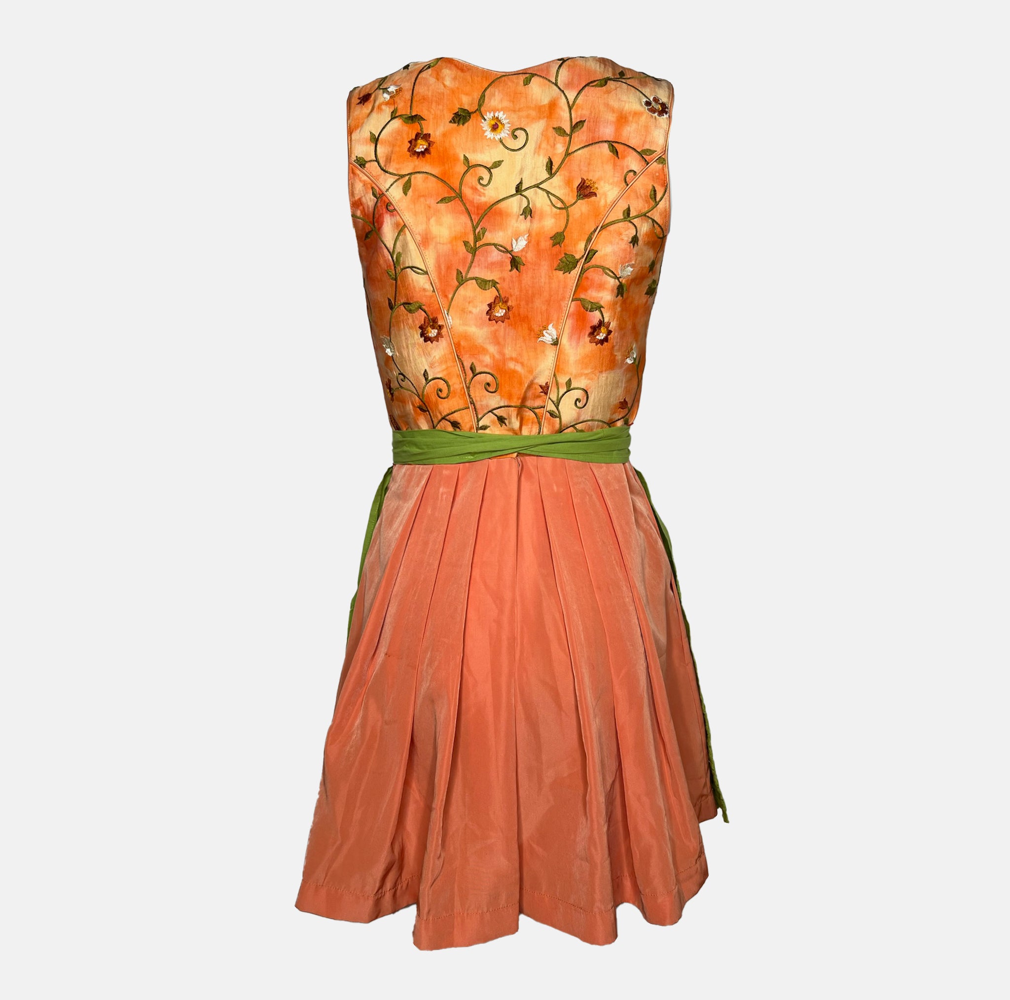 Tramontana Bavarian rental dirndl with orange embroidered satin bodice and green embroidered apron, available at Versatile OTM in Munich.