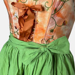 Tramontana Bavarian rental dirndl with orange embroidered satin bodice and green embroidered apron, available at Versatile OTM in Munich.