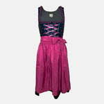Black and pink Bavarian rental dirndl with embroidered bodice, pink lace-up ribbons, and fuchsia apron, available at Versatile OTM in Munich, owned by Beer&Pretzel Tours.