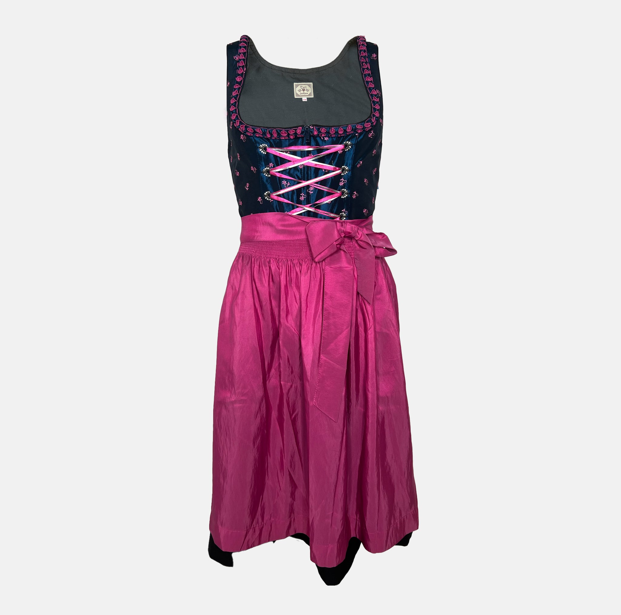Black and pink Bavarian rental dirndl with embroidered bodice, pink lace-up ribbons, and fuchsia apron, available at Versatile OTM in Munich, owned by Beer&Pretzel Tours.