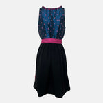 Black and pink Bavarian rental dirndl with embroidered bodice, pink lace-up ribbons, and fuchsia apron, available at Versatile OTM in Munich, owned by Beer&Pretzel Tours.