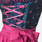 Black and pink Bavarian rental dirndl with embroidered bodice, pink lace-up ribbons, and fuchsia apron, available at Versatile OTM in Munich, owned by Beer&Pretzel Tours.