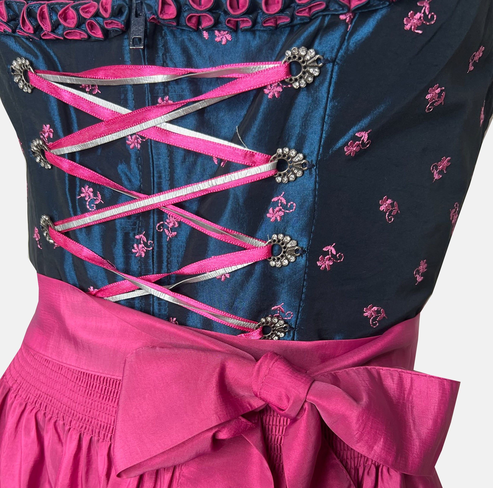 Black and pink Bavarian rental dirndl with embroidered bodice, pink lace-up ribbons, and fuchsia apron, available at Versatile OTM in Munich, owned by Beer&Pretzel Tours.