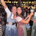 Two woman wearing a traditional German Krüger Dirndl and Wenger Dirndl ready to rent on Versatile OTM. Dirndl Bea and Wenger Dirndl with Dirndl Blouse