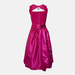 Ma.le.ma handmade dirndl rental via Versatile – vibrant fuchsia silk dirndl dress with bow apron, perfect for Oktoberfest in Munich