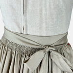 Handmade Versatile Collection Dirndl in light taupe with pleated neckline and flowing apron. Elegant, minimal, and made in Germany.