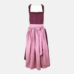 Exclusive Versatile Collection dirndl in berry with soft rose apron. Handmade in Germany, sustainable and fashion-forward. Rent a dirndl!