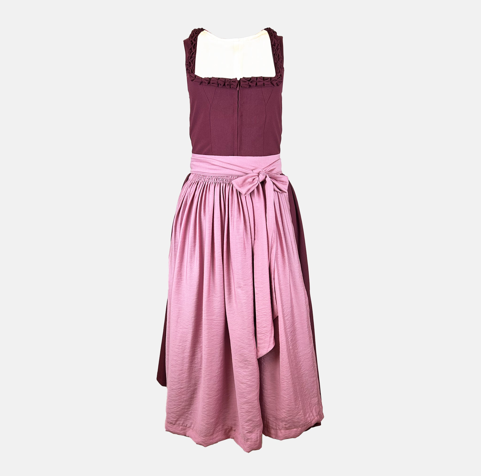 Exclusive Versatile Collection dirndl in berry with soft rose apron. Handmade in Germany, sustainable and fashion-forward. Rent a dirndl!