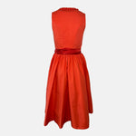 Handmade red Versatile Collection Dirndl with tone-in-tone bodice and apron – modern, elegant, and available to rent at Versatile OTM.