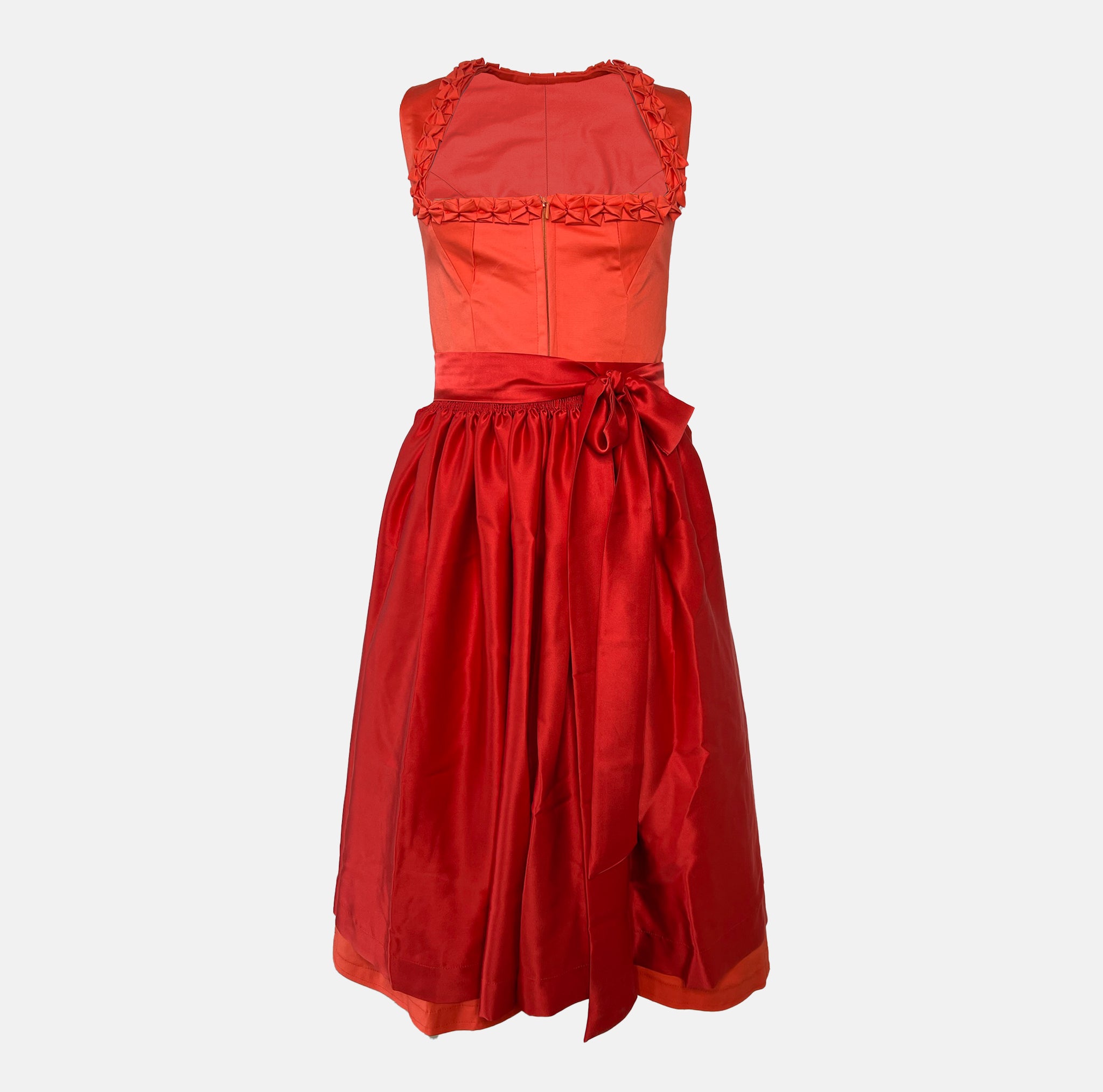 Handmade red Versatile Collection Dirndl with tone-in-tone bodice and apron – modern, elegant, and available to rent at Versatile OTM.