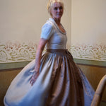 Rent Dirndl Christine in Munich: refined Versatile Collection dirndl with light taupe linen, pleated front, and flattering 70 cm skirt—Oktoberfest ready.